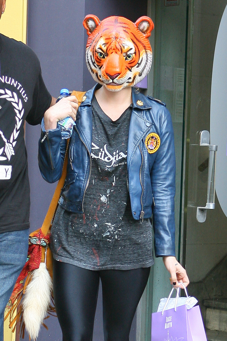 Ke$ha leaves the Tracie Martyn Salon in NYC wearing a tiger mask and cowboy boots as she gets into a taxi cab