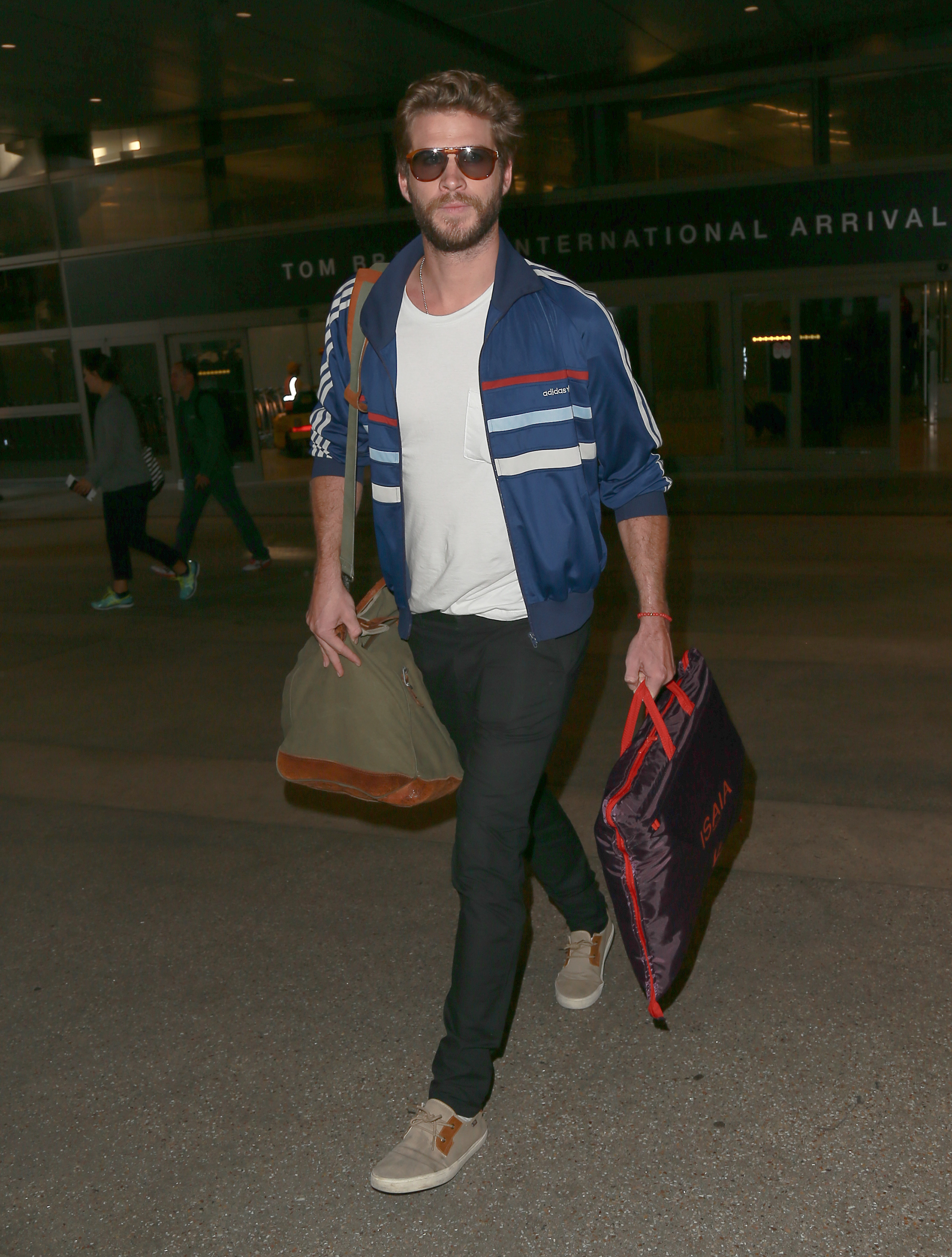 Exclusive... Liam Hemsworth Arrives On A Flight At LAX