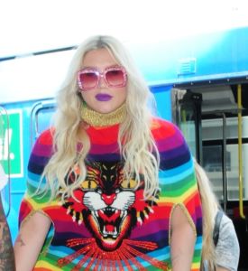 Kesha stands out in a bright colorful outfit as she departs LAX with her boyfriend Brad Ashenfelter