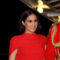 Meghan Stuns in a Be-Caped Red SAFiYAA Gown