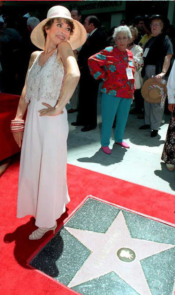 Rita Moreno poses for photos after receiving her s