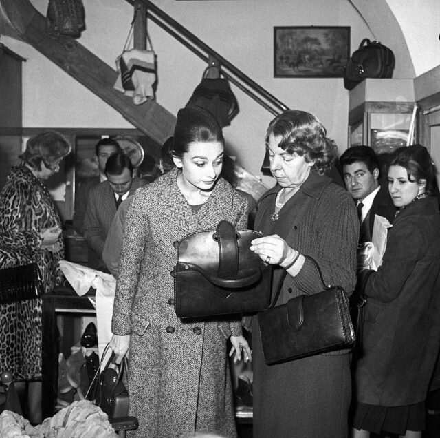 Audrey Hepburn checking a bag