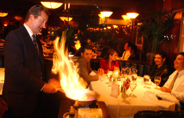 Dal Rae, one of LA's great steakhouses; owner Lorin Smith flames a banana flambe for customers in on