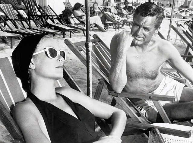 Cary Grant and Grace Kelly Lounging on Beach