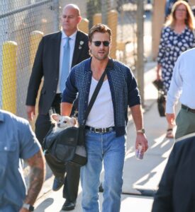 Glen Powell Looks Casually Good Carrying His Dog Around